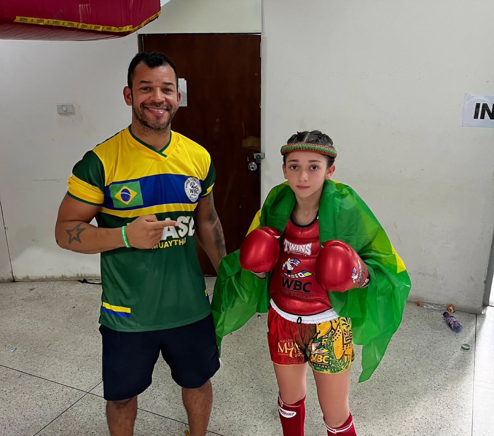 Coach with a young fighter in WBC Muay Thai kit